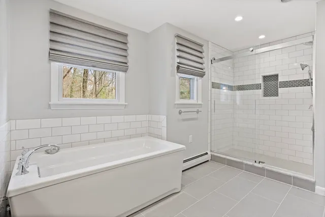a bathroom with a bathtub and shower