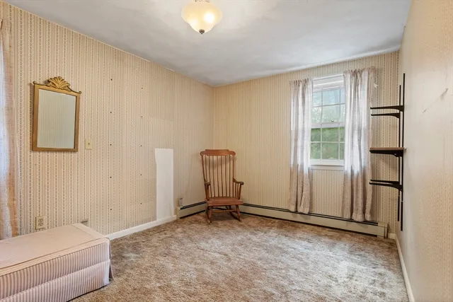 a view of a livingroom with furniture and a window