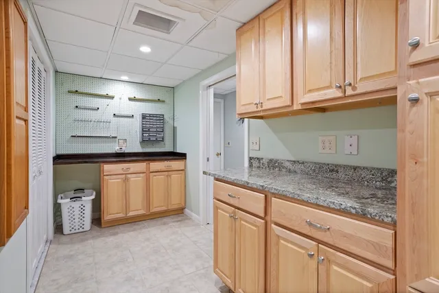a kitchen with granite countertop a sink and cabinets