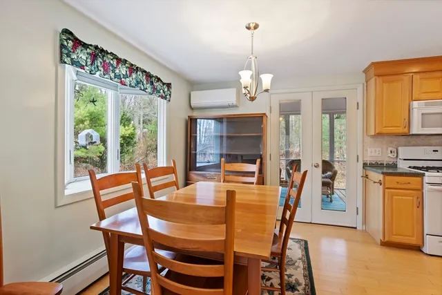 a dining room with furniture a chandelier and window