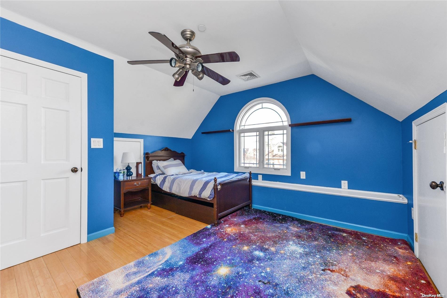 147-32 69th Road Queens, NY 11367 - Photo 13 of 24 a bedroom with a bed and a window