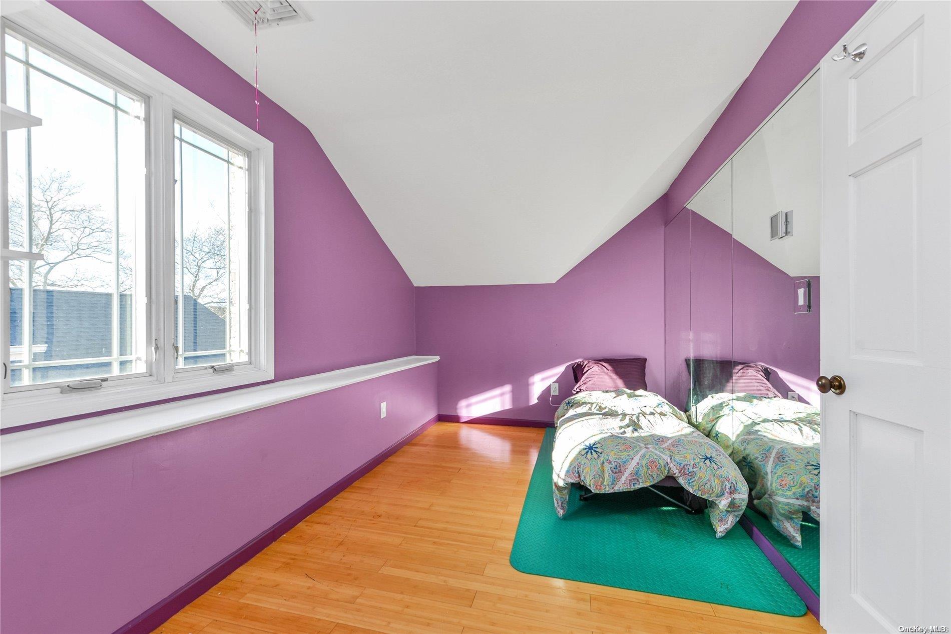 147-32 69th Road Queens, NY 11367 - Photo 15 of 24 a bedroom with a bed and a window