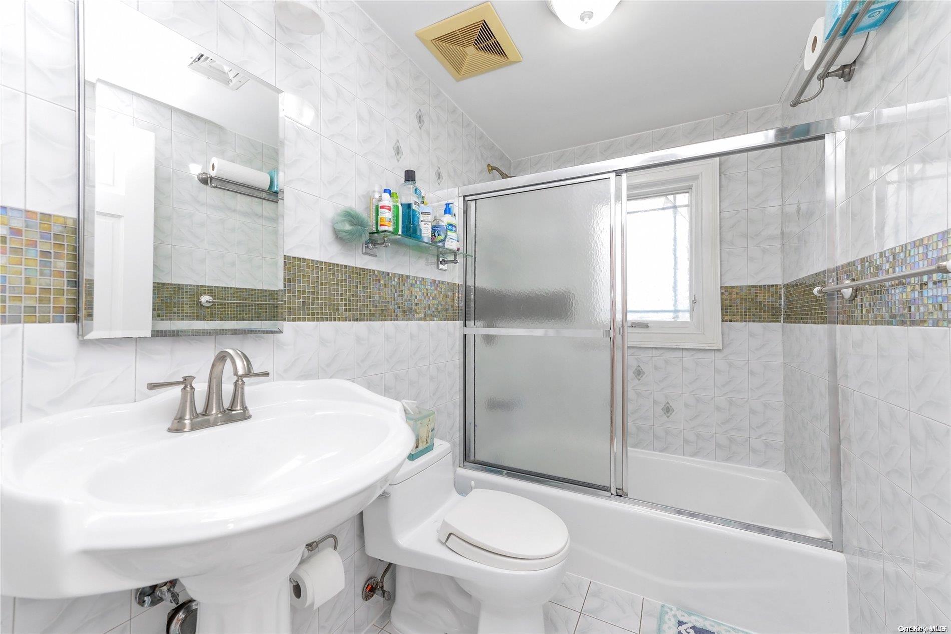 147-32 69th Road Queens, NY 11367 - Photo 17 of 24 a bathroom with a sink toilet and shower