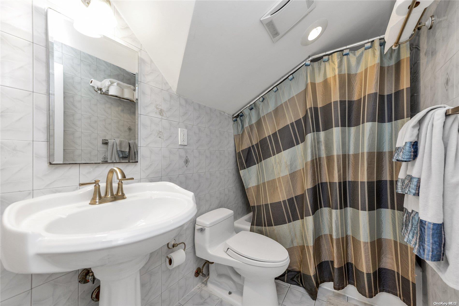 147-32 69th Road Queens, NY 11367 - Photo 18 of 24 a bathroom with a sink toilet and shower