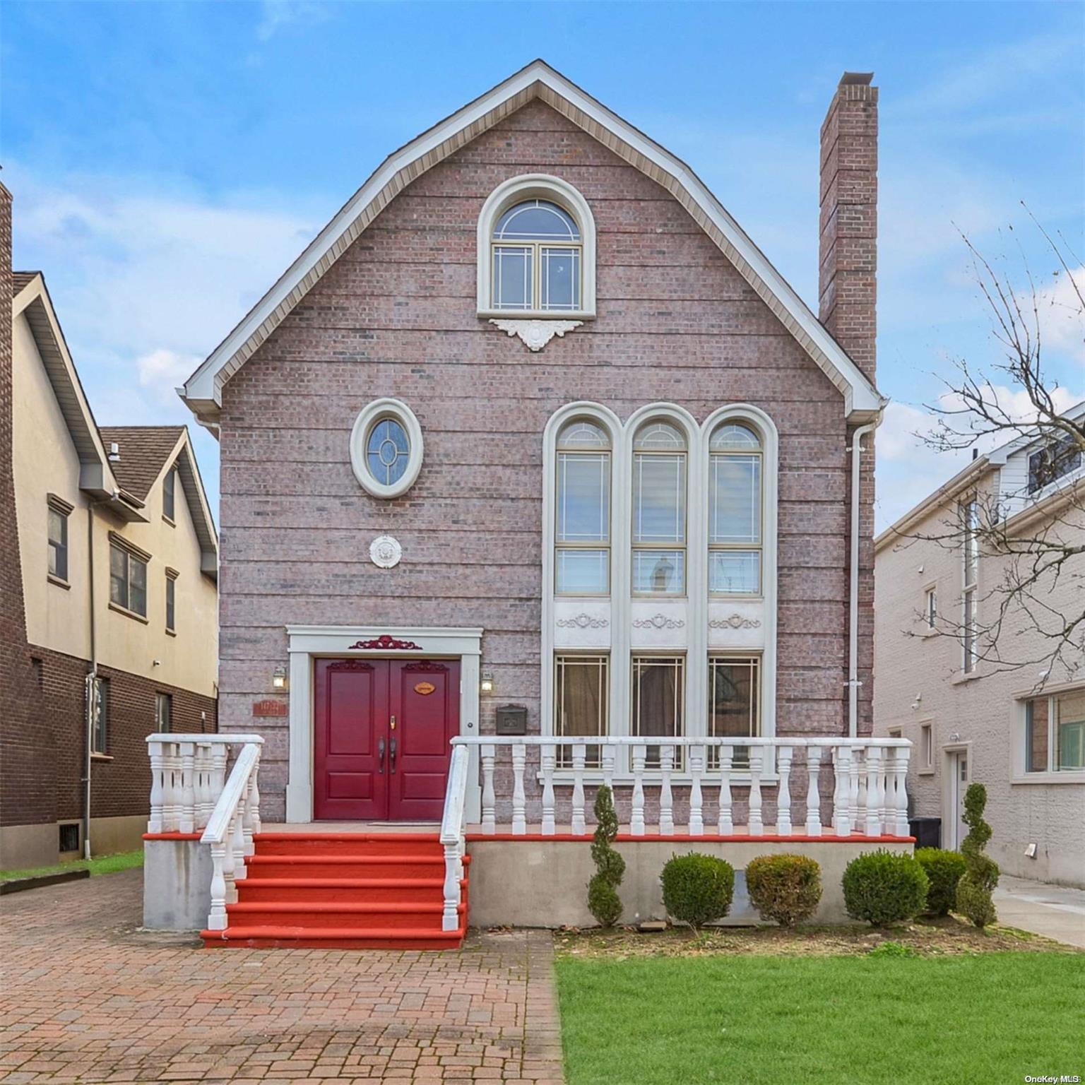147-32 69th Road Queens, NY 11367 - Photo 2 of 24 a front view of a house with a yard