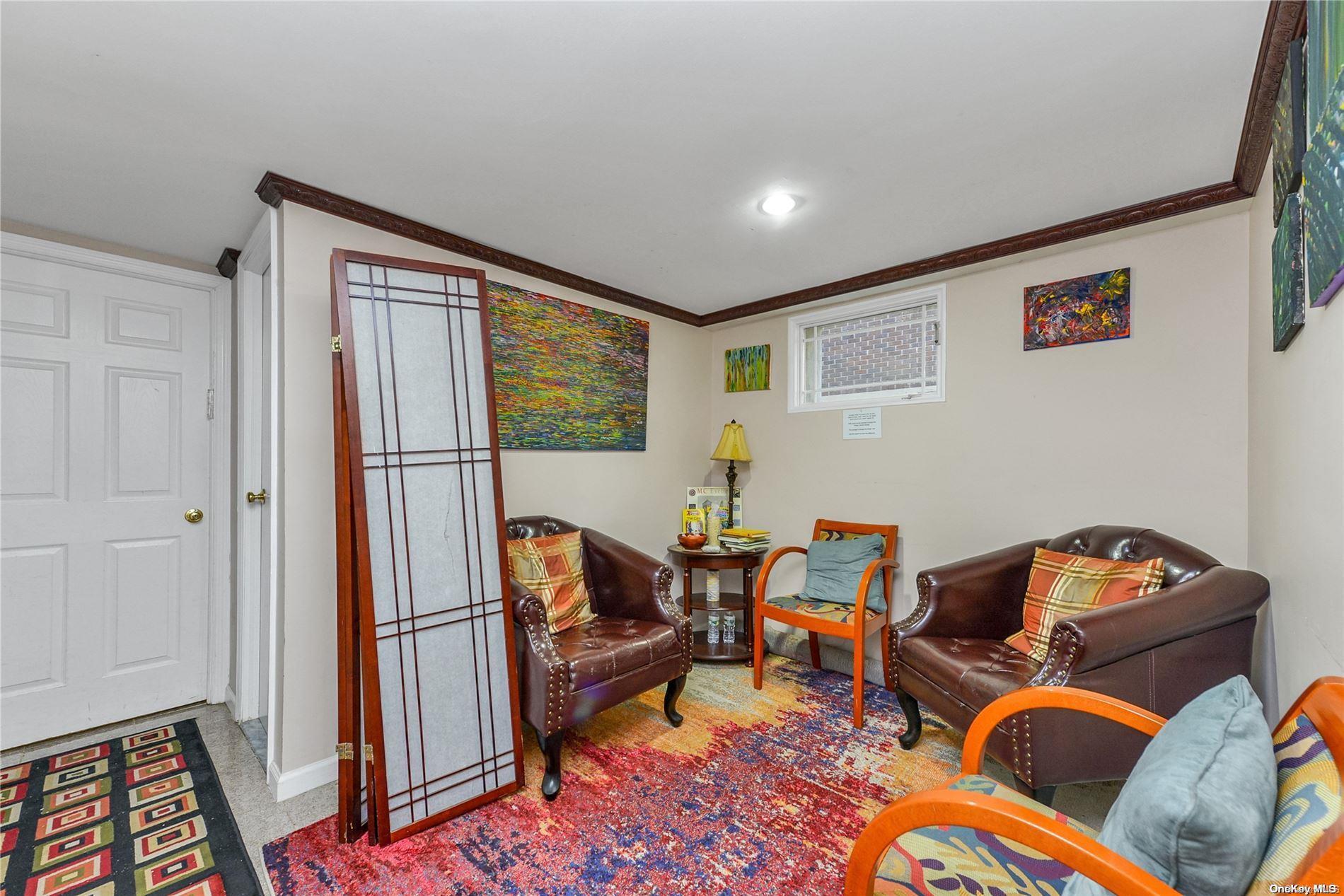 147-32 69th Road Queens, NY 11367 - Photo 22 of 24 a living room with furniture and a gate