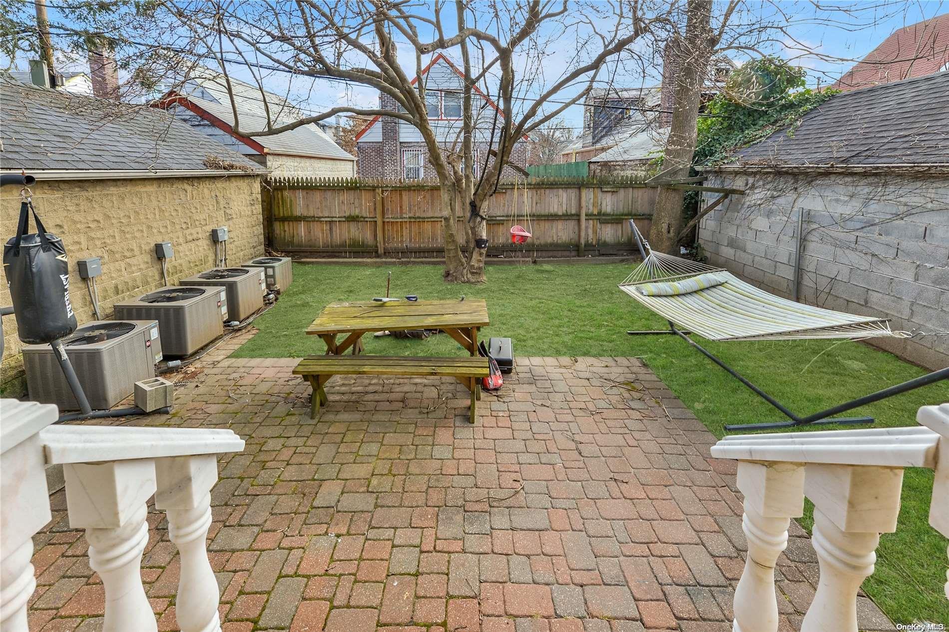 147-32 69th Road Queens, NY 11367 - Photo 23 of 24 a view of a backyard with table and chairs