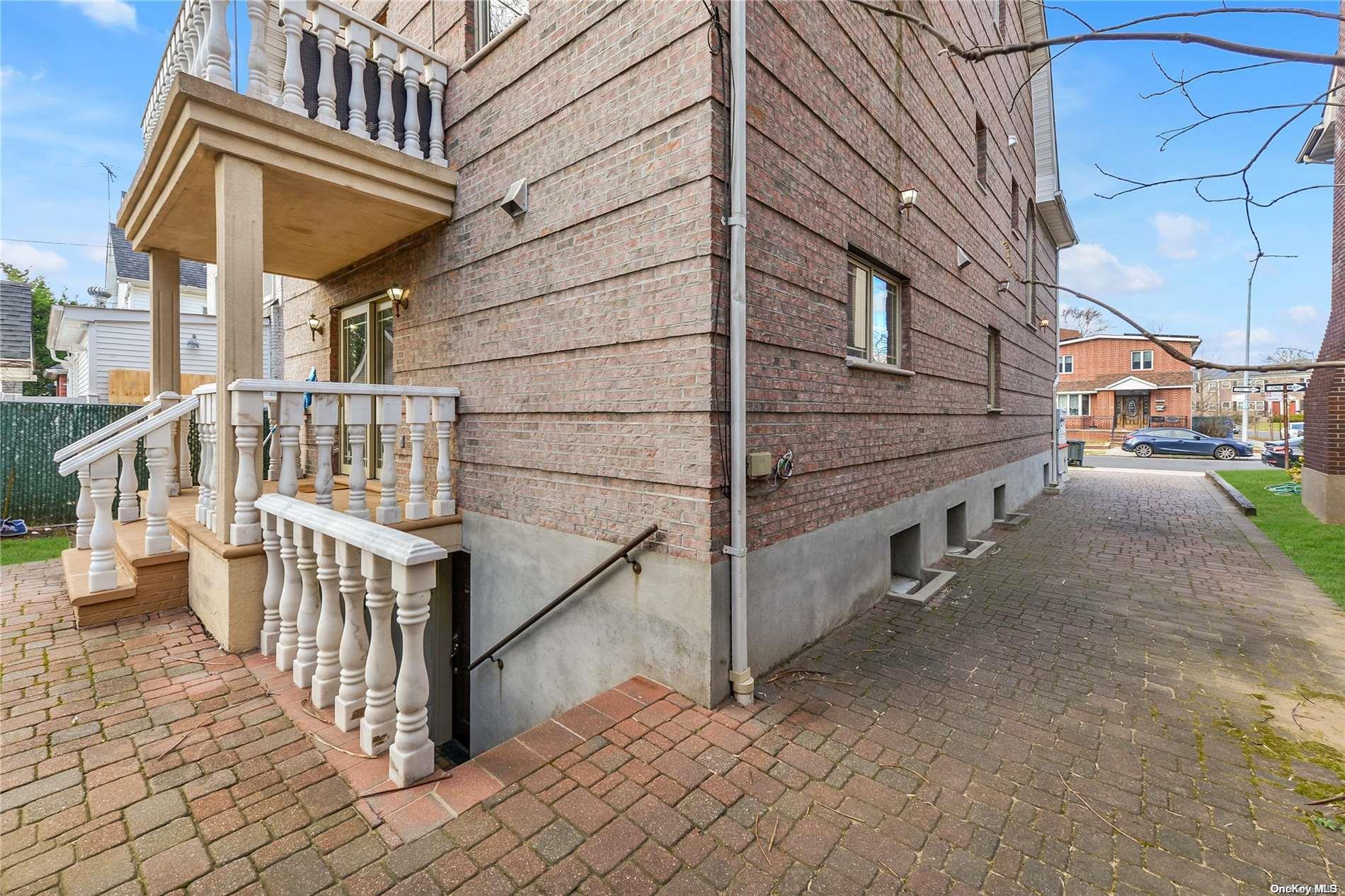 147-32 69th Road Queens, NY 11367 - Photo 24 of 24 a view of a house with a small yard and wooden fence