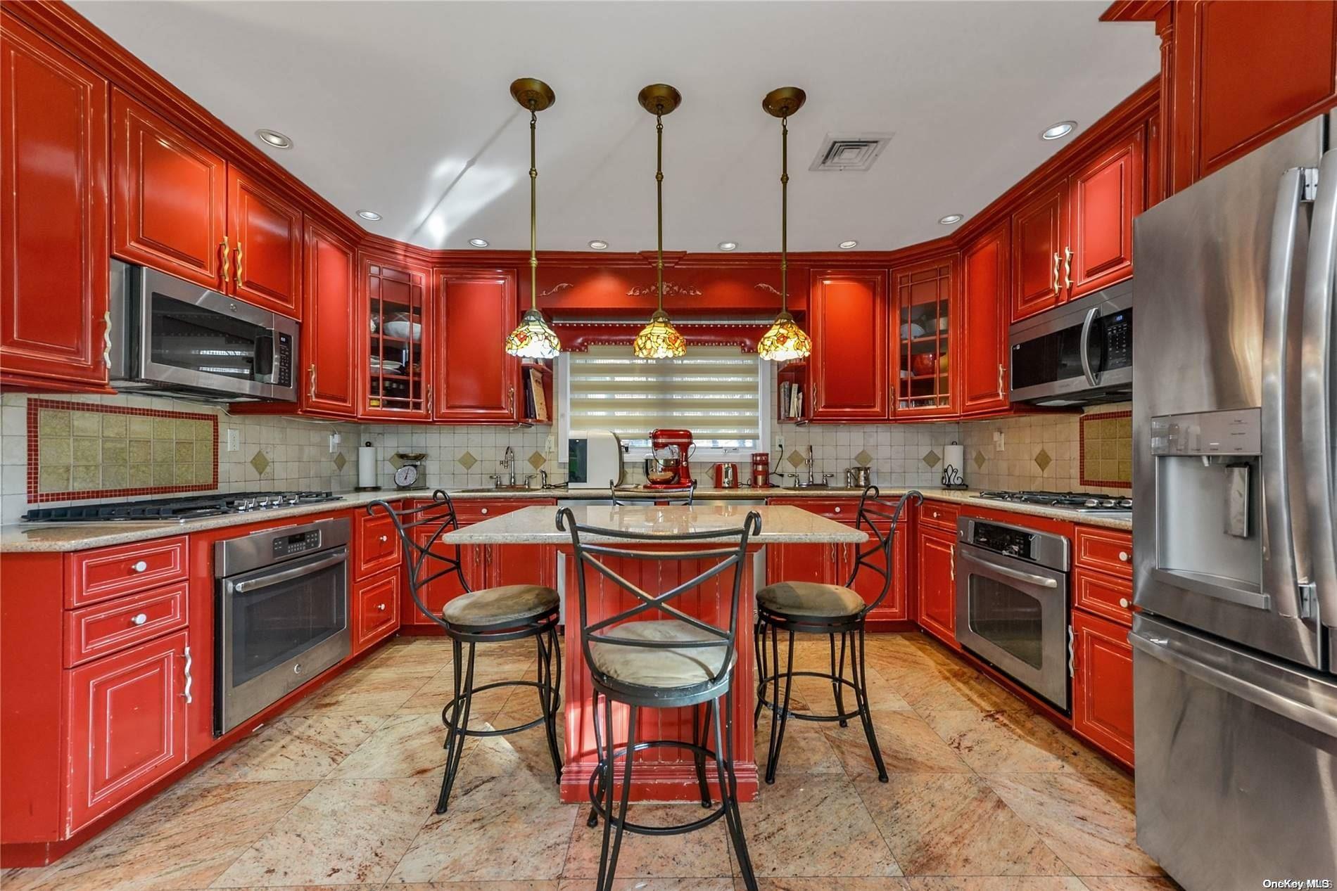147-32 69th Road Queens, NY 11367 - Photo 5 of 24 a kitchen with stainless steel appliances granite countertop a stove a sink dishwasher a microwave oven with granite countertops and cabinets
