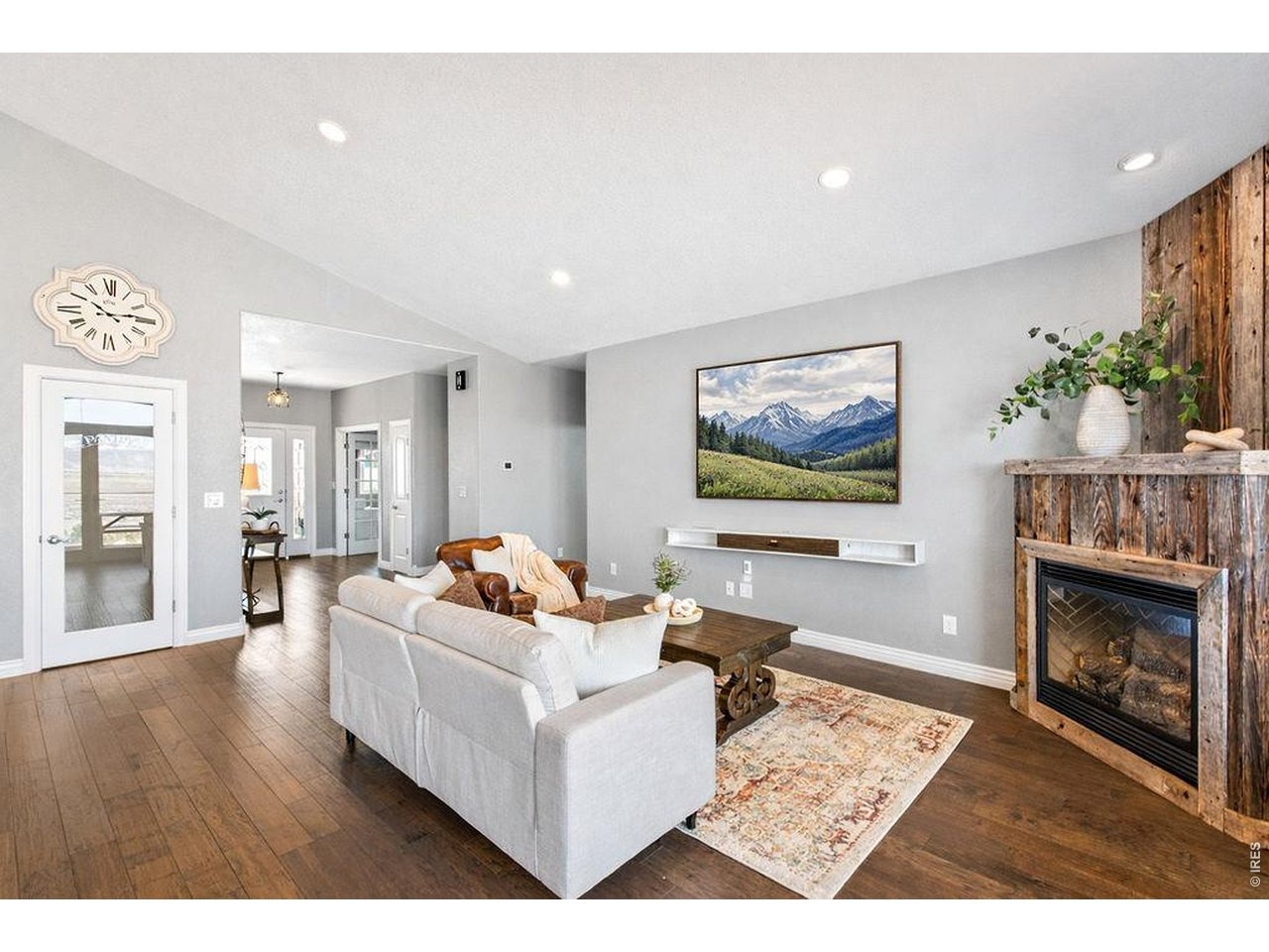 3050 Native Court Wellington, CO 80549 - Photo 5 of 49 Bright and inviting living space with abundant natural light and a cozy fireplace focal point