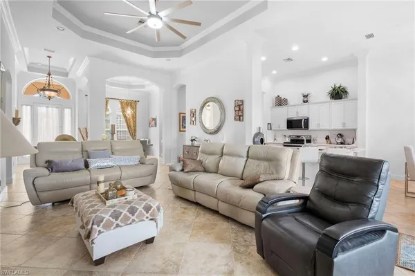 a living room with furniture and view of kitchen