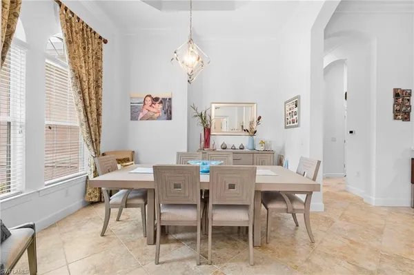 a view of a dining room with furniture and a chandelier