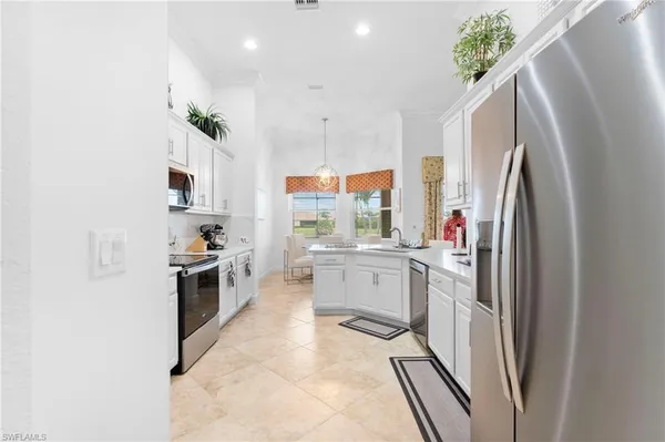 a kitchen with cabinets and window