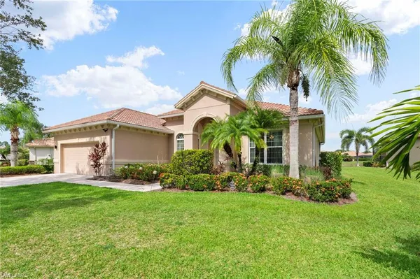 a front view of house with yard and green space