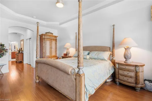 a bedroom with bed window and flat screen tv
