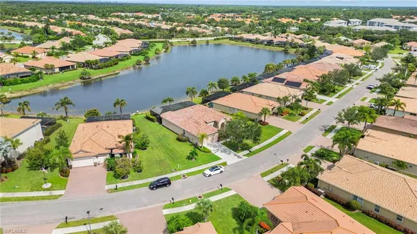 an aerial view of residential houses with outdoor space and street view