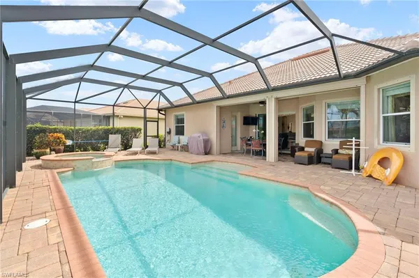 a swimming pool with outdoor seating