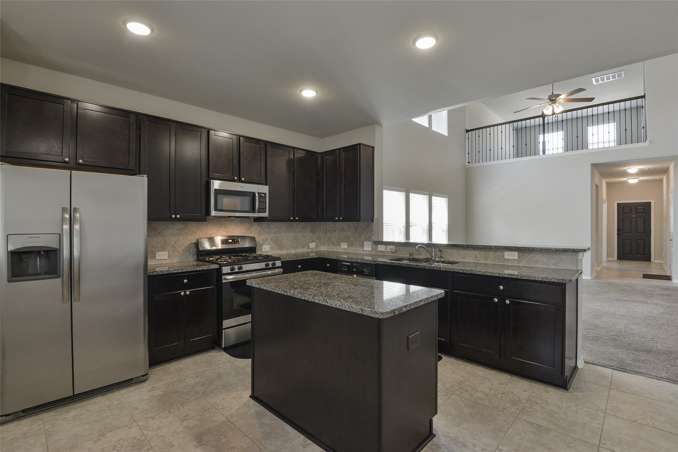 614 Pequin Road Crosby, TX 77532 - Photo 12 of 43 a kitchen with stainless steel appliances granite countertop a sink stove and refrigerator