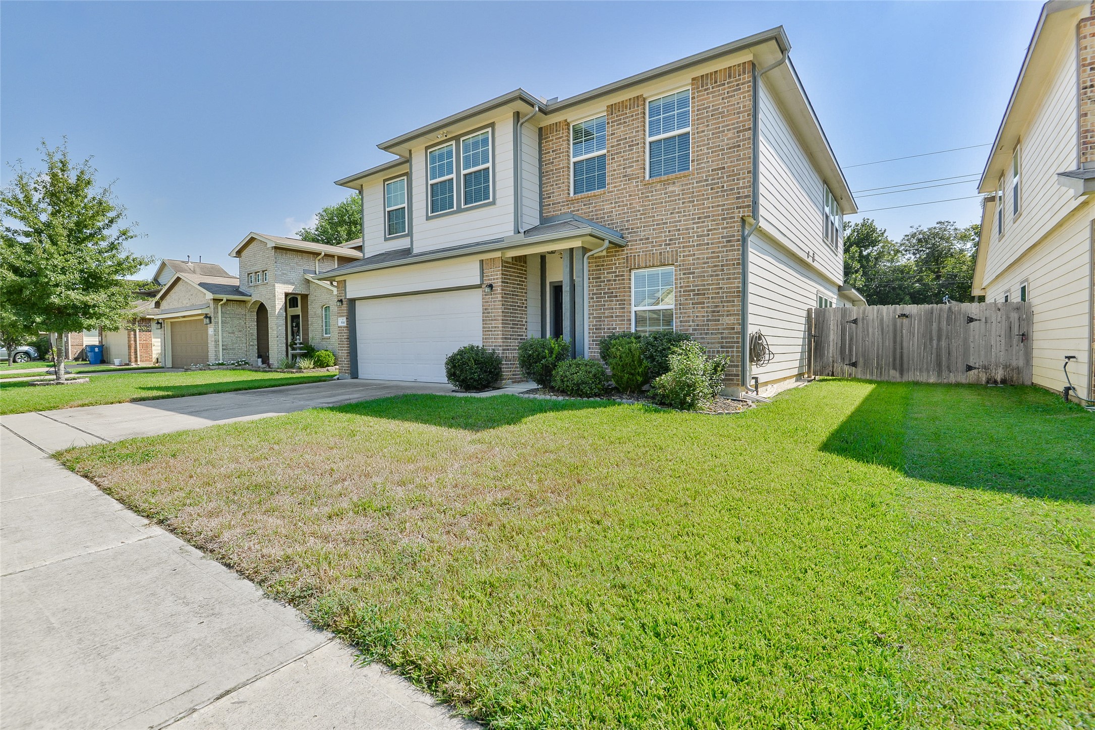 614 Pequin Road Crosby, TX 77532 - Photo 2 of 43 This is a two-story, brick and siding home with a well-maintained front lawn and attached two-car garage. The house features multiple windows for natural light and a fenced backyard, ideal for privacy. Located in a suburban neighborhood with similar style homes.