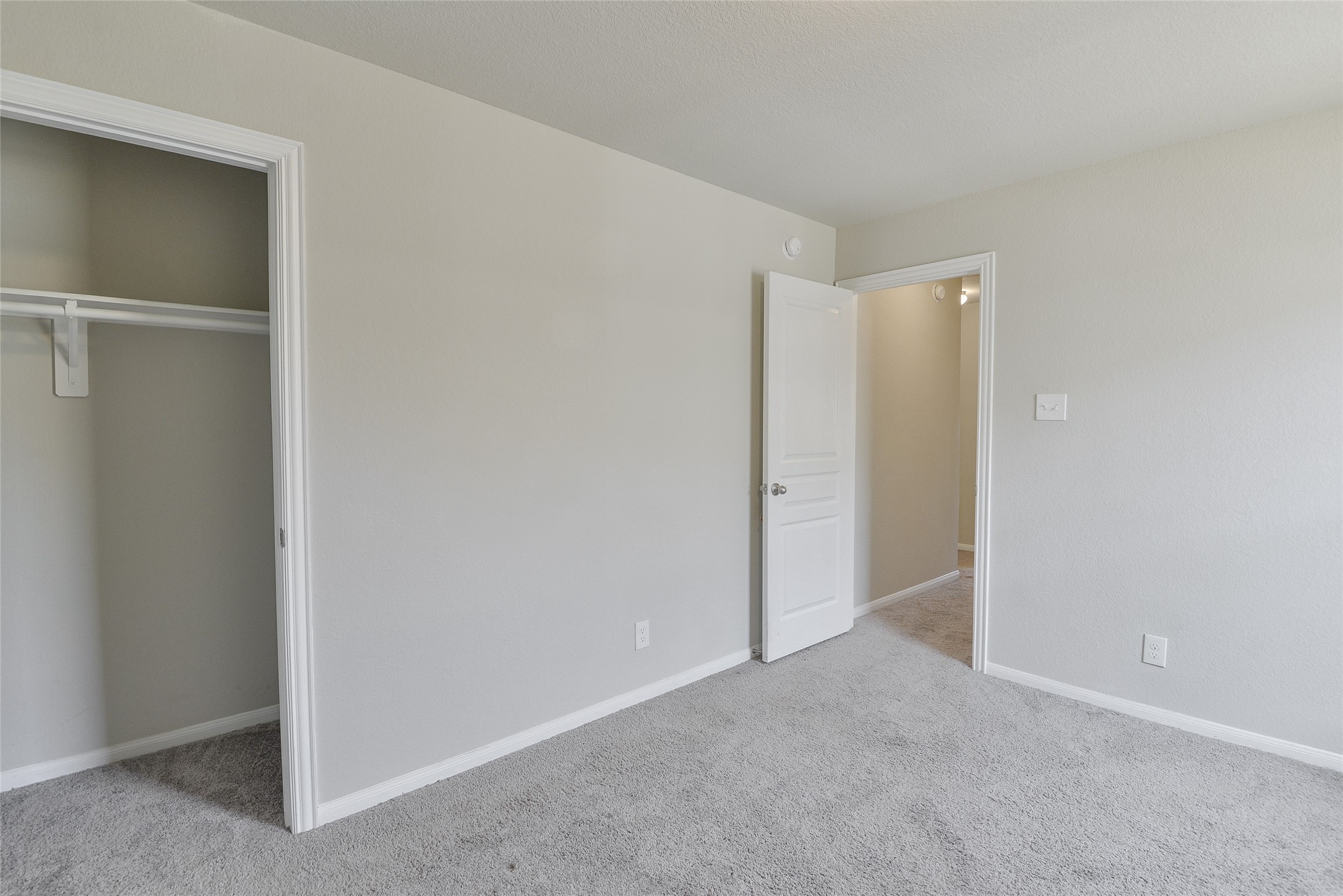 614 Pequin Road Crosby, TX 77532 - Photo 34 of 43 This photo shows a carpeted 3rd bedroom with neutral walls. There's a closet with a hanging rod. The space is bright and simple, ideal for personalization.