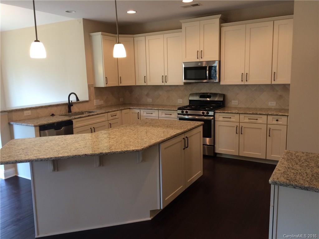 160 Kentmere Lane, Unit 81 Clover, SC 29710 - Photo 12 of 24 a kitchen with stainless steel appliances granite countertop a sink a stove and a microwave