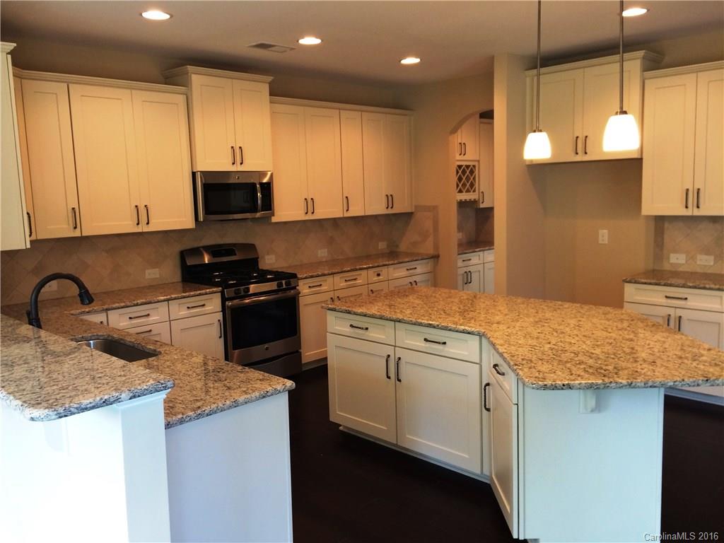 160 Kentmere Lane, Unit 81 Clover, SC 29710 - Photo 13 of 24 a kitchen with kitchen island granite countertop a sink a counter top space appliances and cabinets