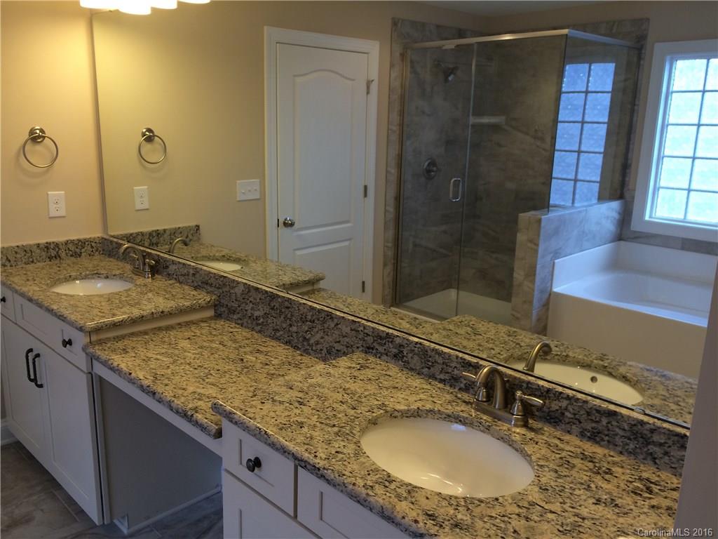 160 Kentmere Lane, Unit 81 Clover, SC 29710 - Photo 19 of 24 a bathroom with a granite countertop sink and a mirror