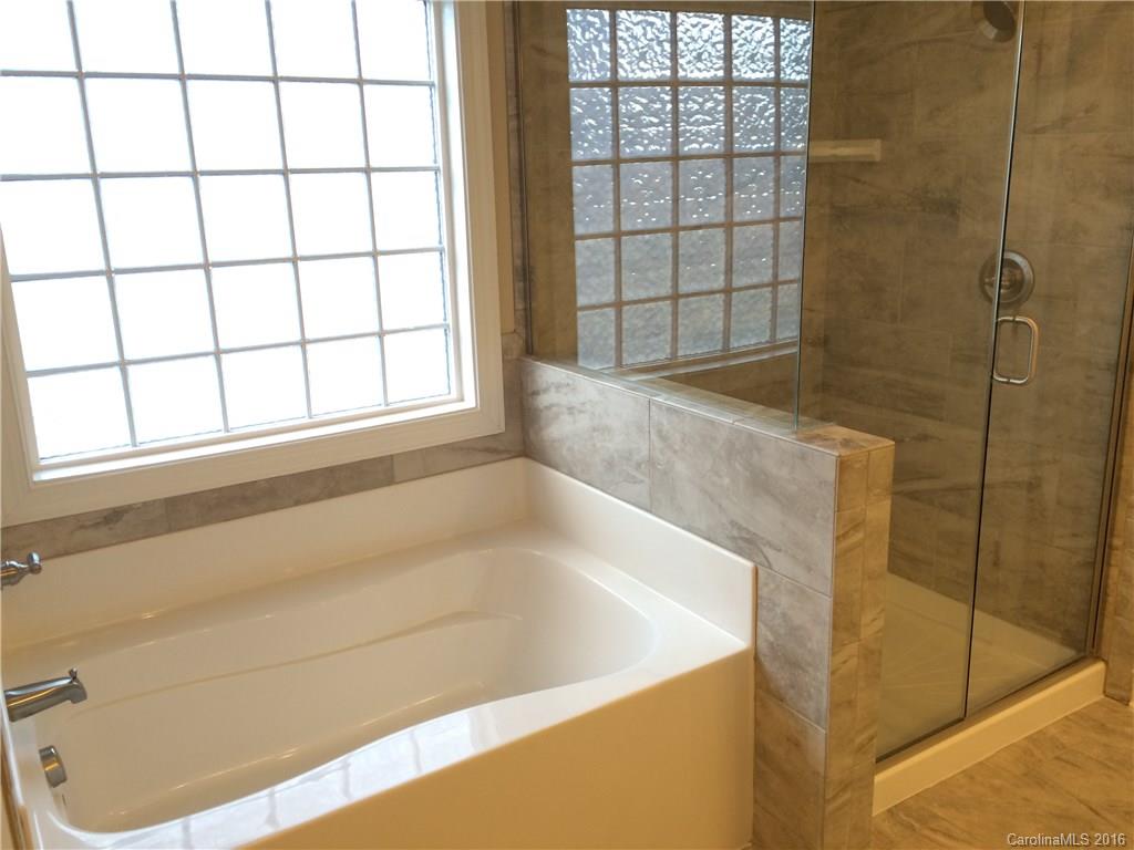 160 Kentmere Lane, Unit 81 Clover, SC 29710 - Photo 21 of 24 a bath tub sitting next to a window