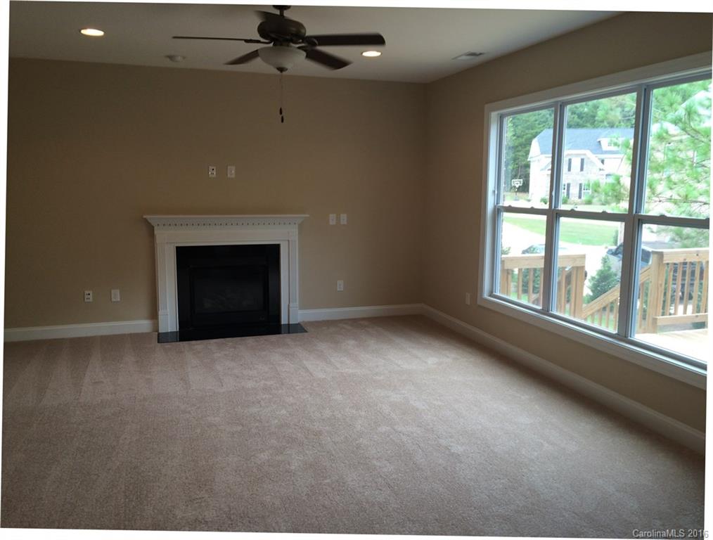 160 Kentmere Lane, Unit 81 Clover, SC 29710 - Photo 7 of 24 an empty room with windows and fireplace