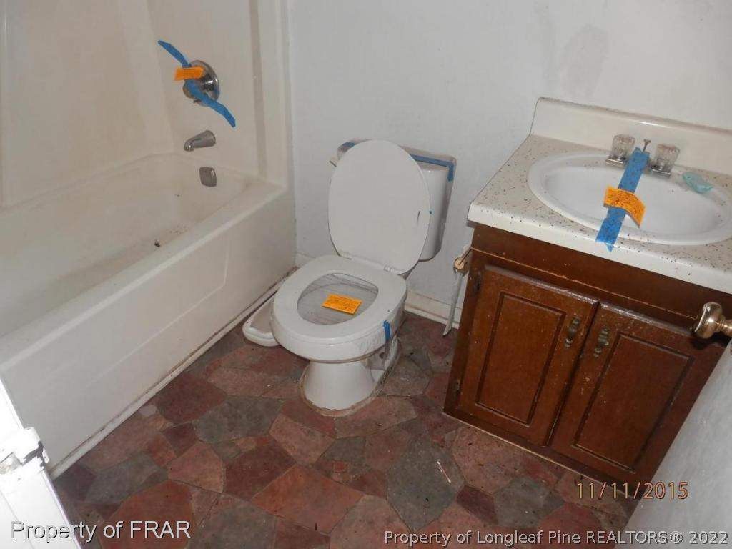 5910 Spinner Road Hope Mills, NC 28348 - Photo 9 of 12 a white toilet sitting next to a bathroom sink and tub