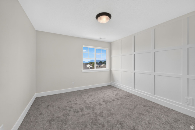 1002 West Temple Rim Lane Payson, UT 84651 - Photo 36 of 68 Interior room featuring a large picture window, board and batten accent wall, neutral wall paint, gray carpet flooring, and a flush mount ceiling light fixture
