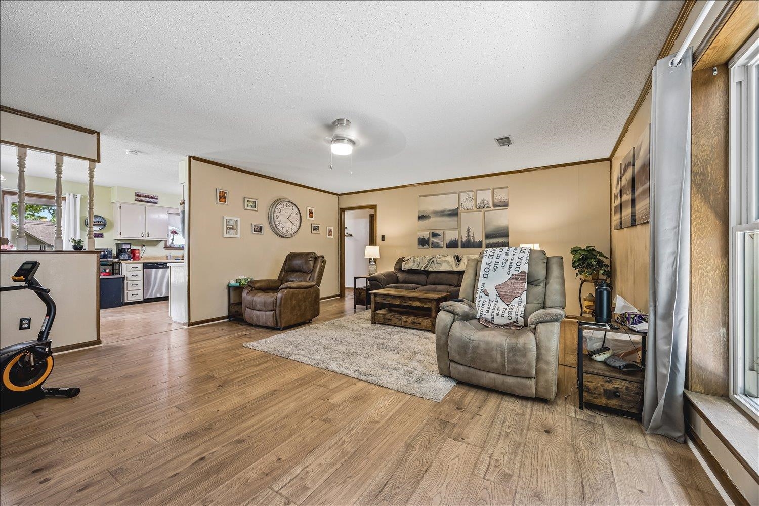 3284 Altruria Road Bartlett, TN 38134 - Photo 10 of 28 Wood-finish flooring extends throughout this expansive living area, featuring neutral wall tones and a ceiling fan