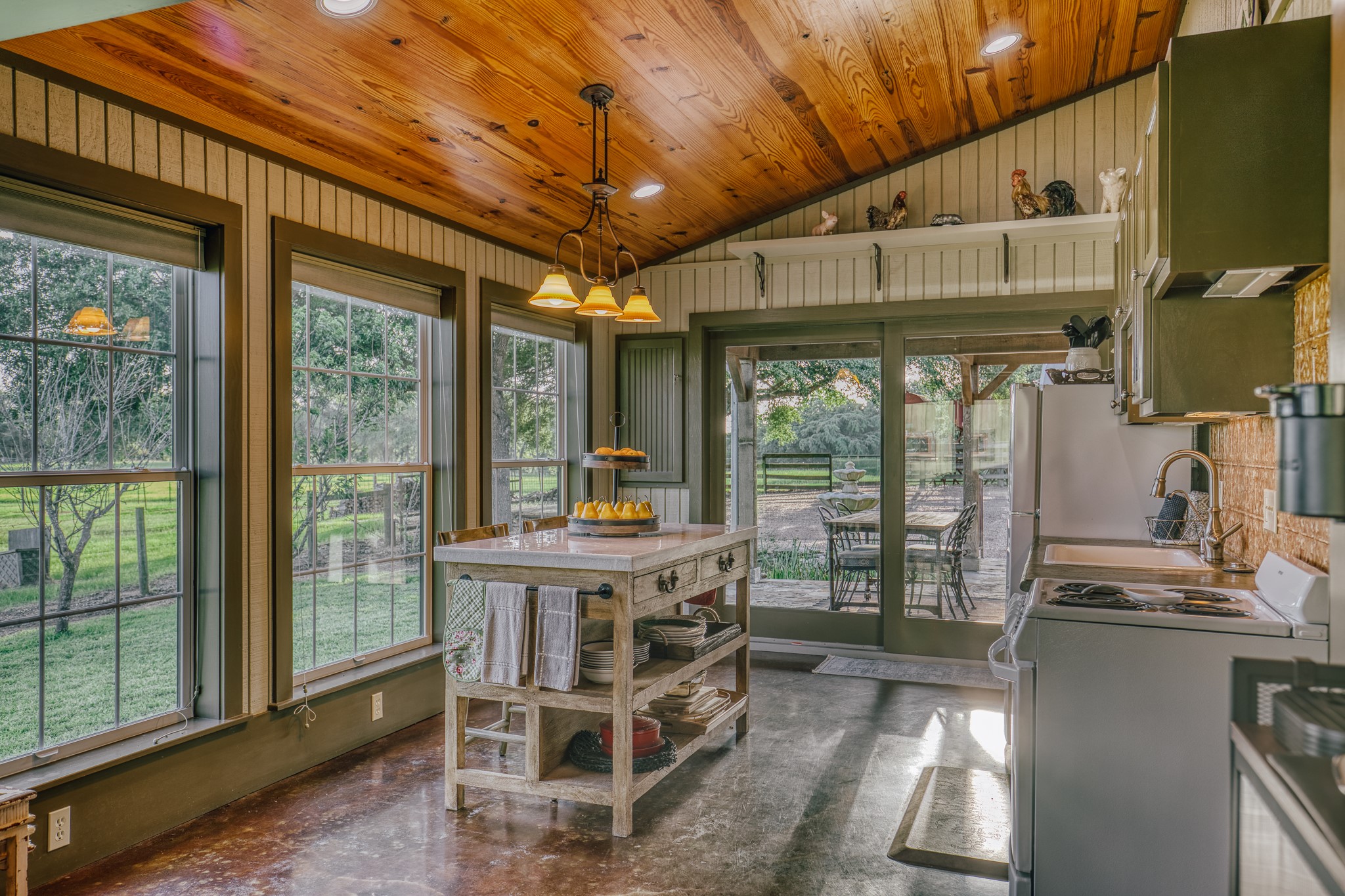 1034 Hilbun Road New Ulm, TX 78950 - Photo 41 of 49 A beautifully crafted guest residence featuring custom built-ins, warm wood accents, quality finishes, spacious gathering areas, full kitchen, two bedrooms, bunk room, and comfortable accommodations for family and guests.