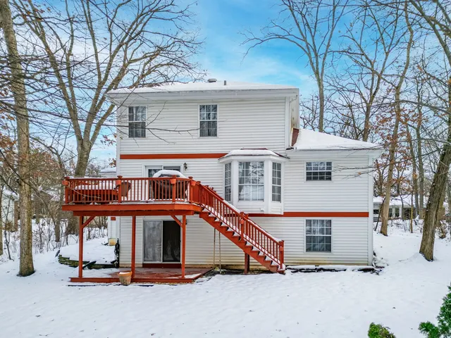 a balcony with wooden floor and outdoor seating