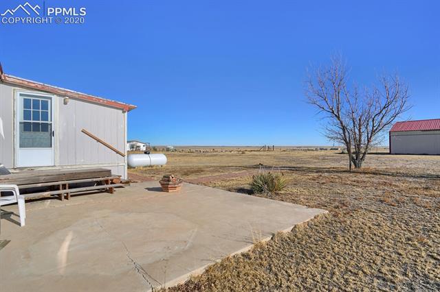 4685 South Yoder Road Yoder, CO 80864 - Photo 24 of 32 Back patio overlooks this beautiful property.