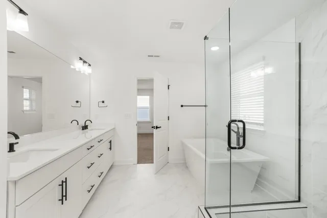 a bathroom with a sink a window and a shower