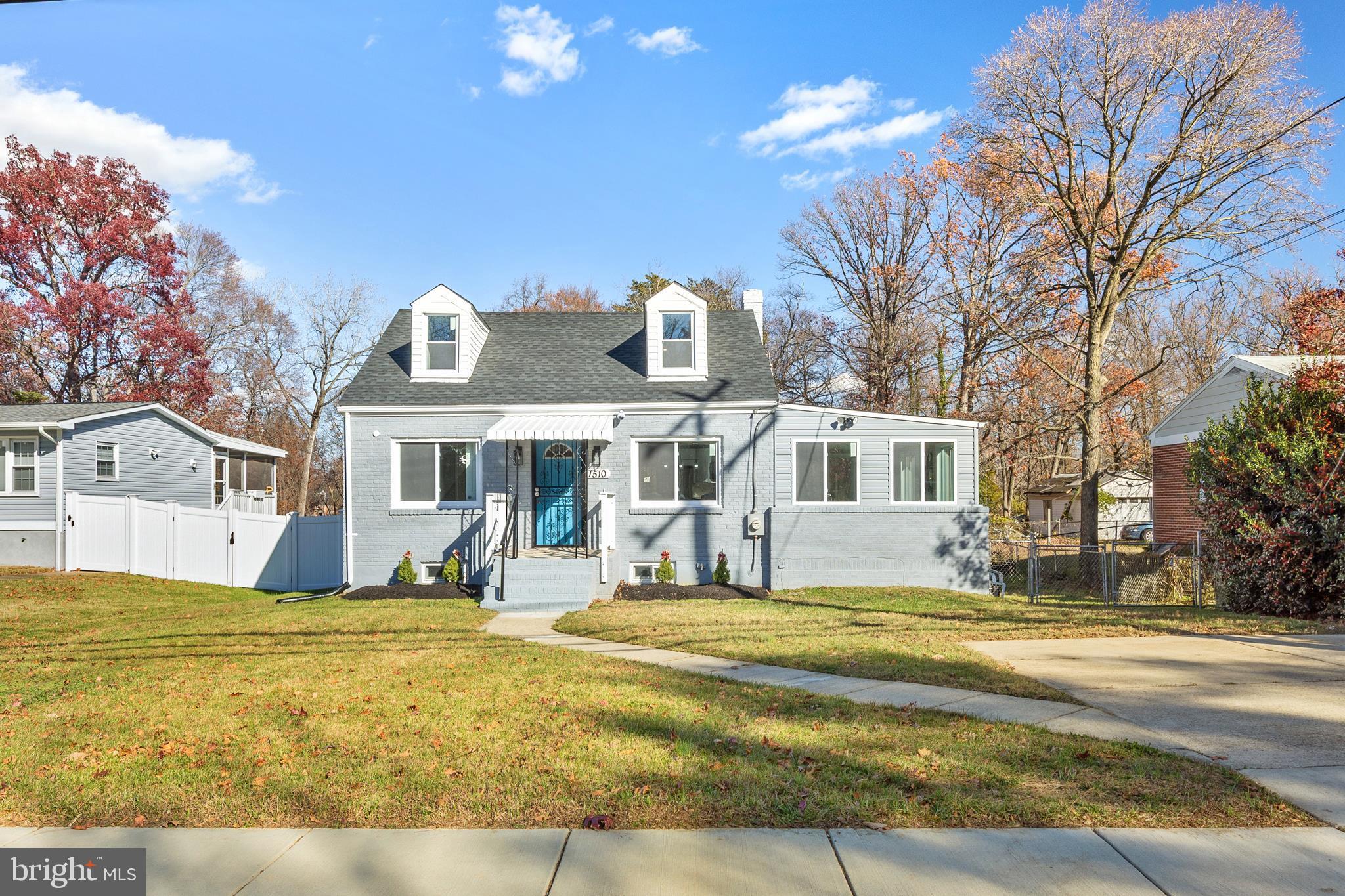 a front view of house with yard and trees around