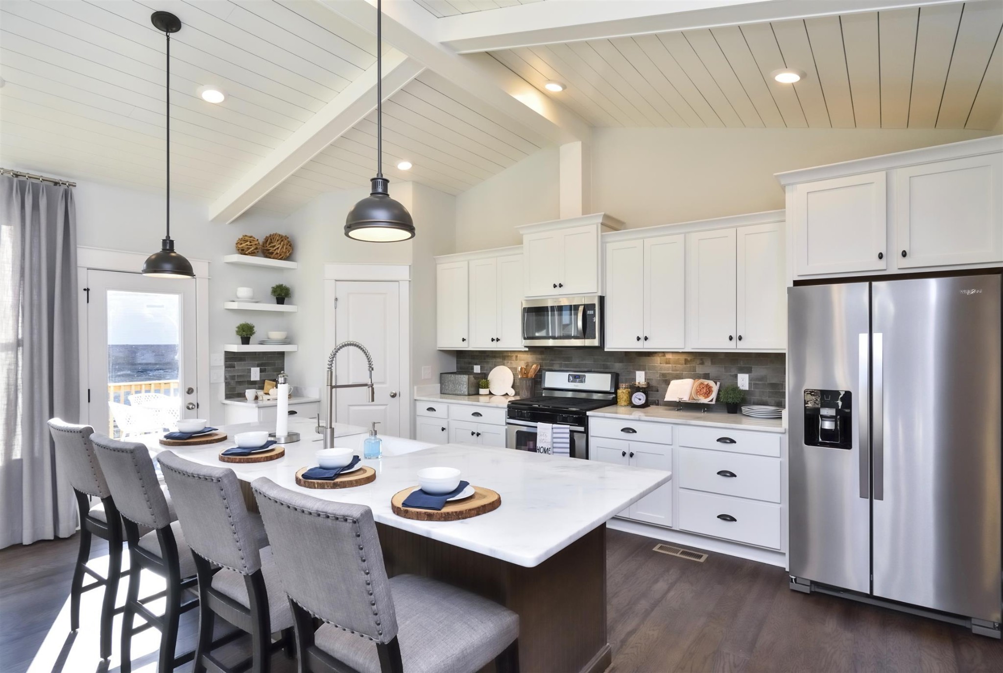 76 Remington Road Lebanon, TN 37090 - Photo 5 of 21 a kitchen with stainless steel appliances kitchen island granite countertop a refrigerator a stove a sink dishwasher a dining table and chairs with wooden floor