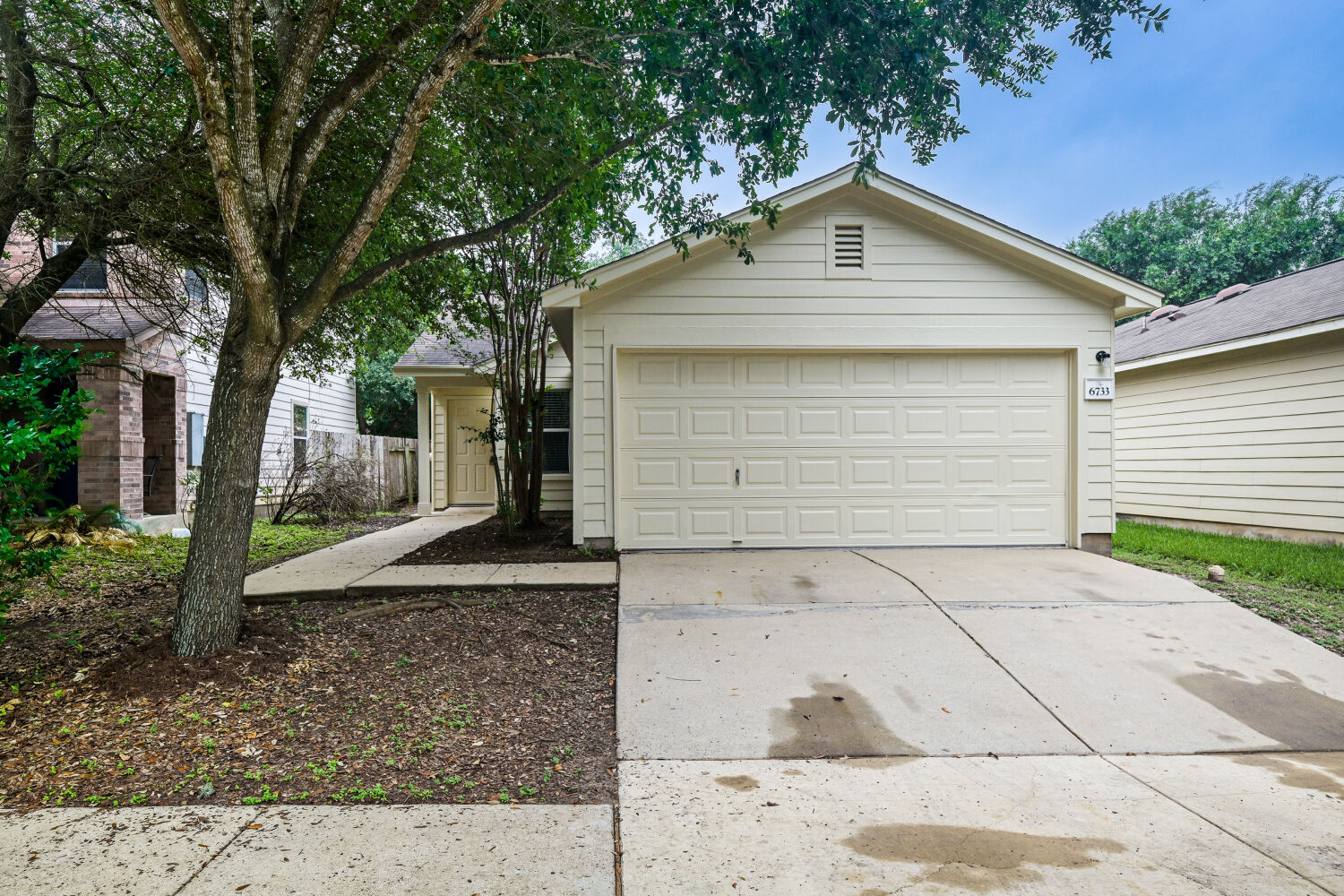 6733 Doyal Drive Austin, TX 78747 - Photo 1 of 28 A classic facade with an attached garage offers inviting curb appeal.