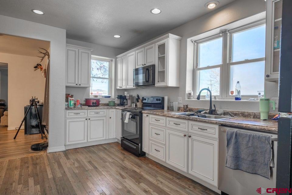 522 East First Street, Unit A & B Trinidad, CO 81082 - Photo 13 of 45 a kitchen with a sink cabinets and window