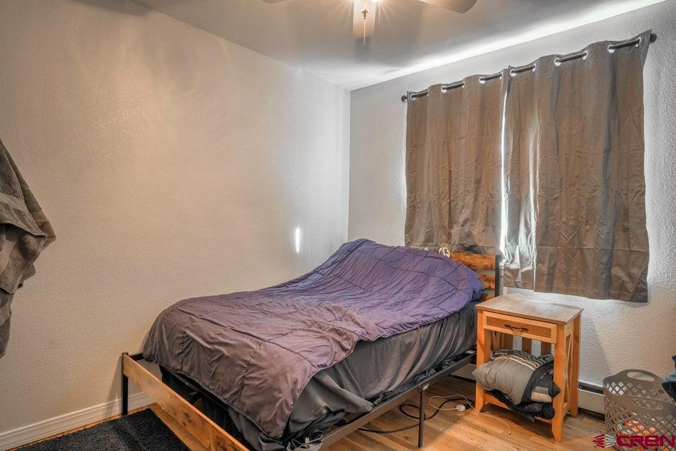 522 East First Street, Unit A & B Trinidad, CO 81082 - Photo 15 of 45 a bedroom with a bed and a window