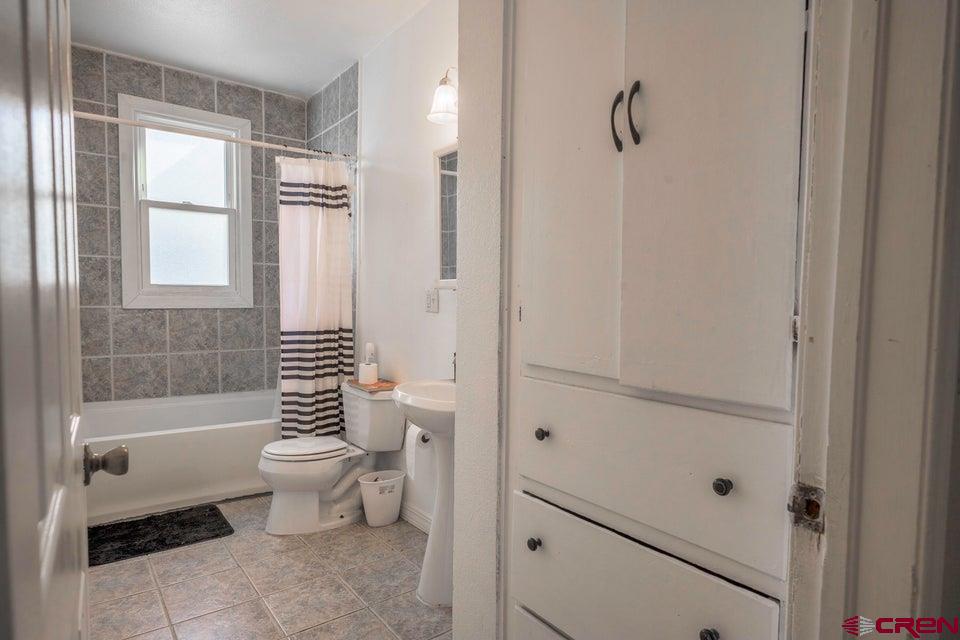 522 East First Street, Unit A & B Trinidad, CO 81082 - Photo 17 of 45 a bathroom with a toilet a sink and a bathtub