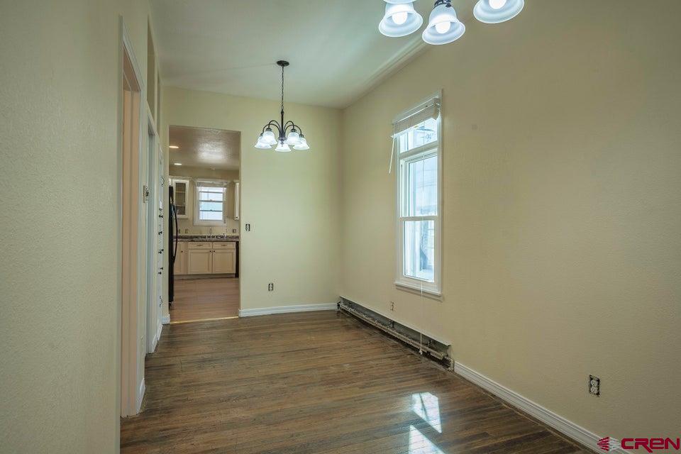522 East First Street, Unit A & B Trinidad, CO 81082 - Photo 19 of 45 a view of an empty room with window and wooden floor