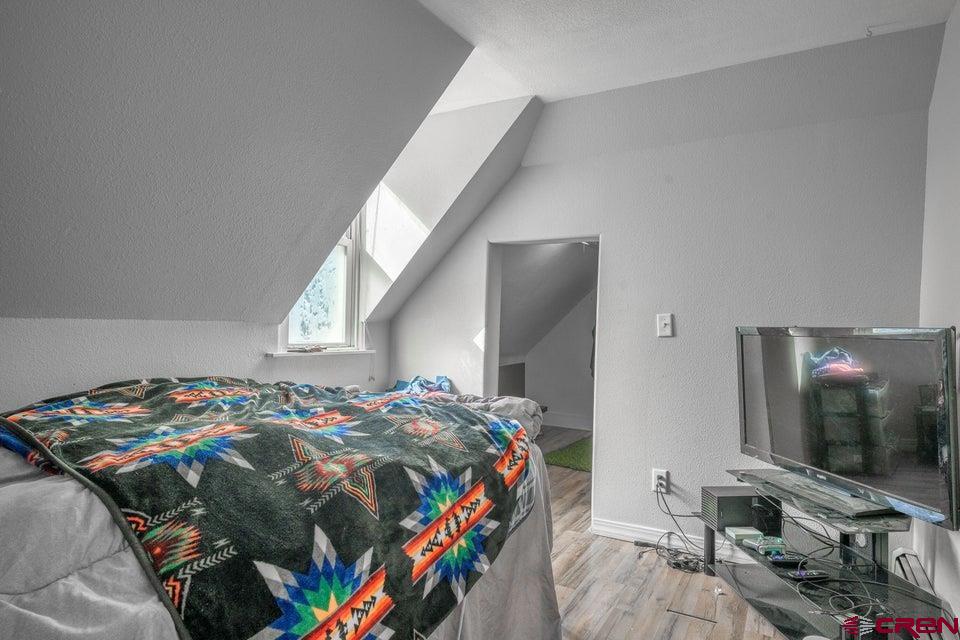 522 East First Street, Unit A & B Trinidad, CO 81082 - Photo 24 of 45 a bedroom with a bed and a flat screen tv