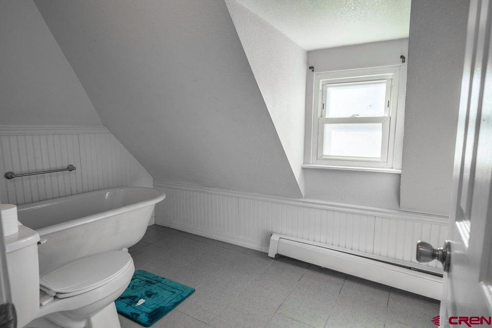 522 East First Street, Unit A & B Trinidad, CO 81082 - Photo 26 of 45 a bathroom with a toilet a sink and a window