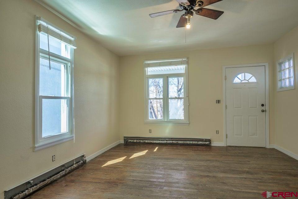 522 East First Street, Unit A & B Trinidad, CO 81082 - Photo 29 of 45 a view of an empty room with a window and wooden floor