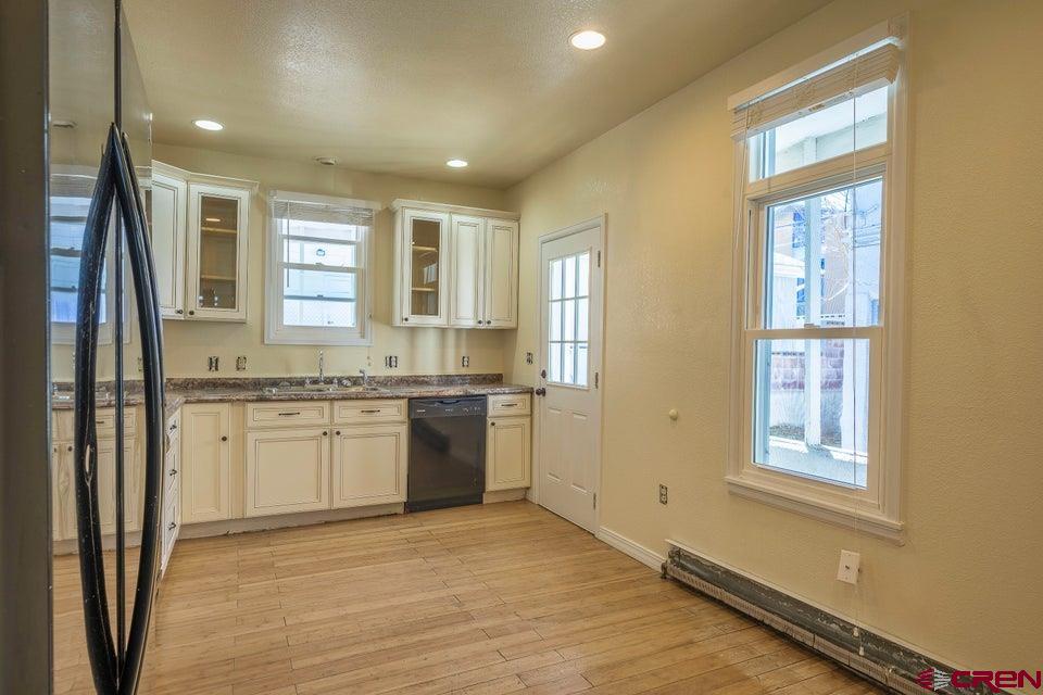 522 East First Street, Unit A & B Trinidad, CO 81082 - Photo 30 of 45 a large bathroom with a granite countertop sink and a window