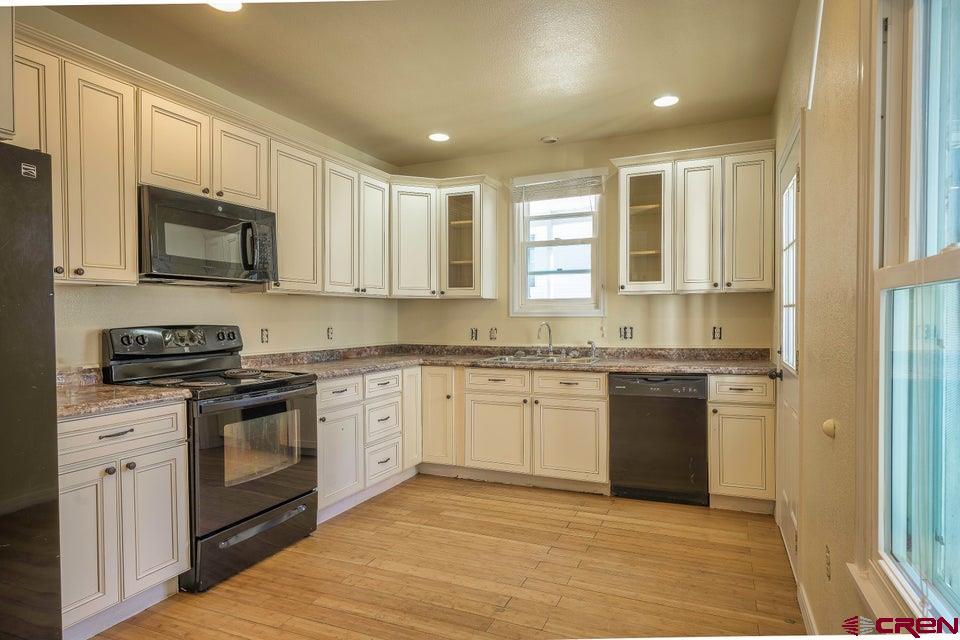 522 East First Street, Unit A & B Trinidad, CO 81082 - Photo 31 of 45 a kitchen with stainless steel appliances granite countertop a stove a sink and a microwave