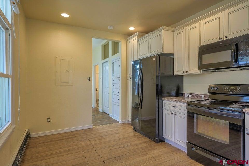 522 East First Street, Unit A & B Trinidad, CO 81082 - Photo 32 of 45 a kitchen with stainless steel appliances a refrigerator stove and microwave