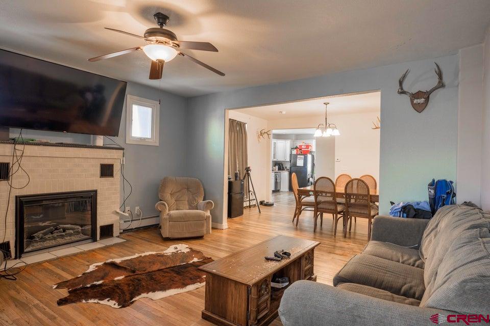 522 East First Street, Unit A & B Trinidad, CO 81082 - Photo 5 of 45 a living room with furniture a flat screen tv and a fireplace